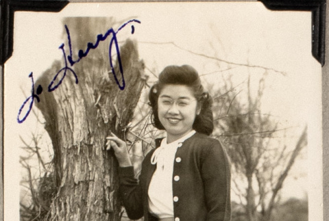 Woman standing by tree trunk (ddr-densho-587-46)