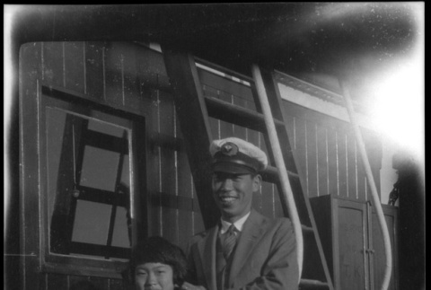 Man and girl posing with life ring of Ryoyo Maru, Yokahama (ddr-densho-426-2001)