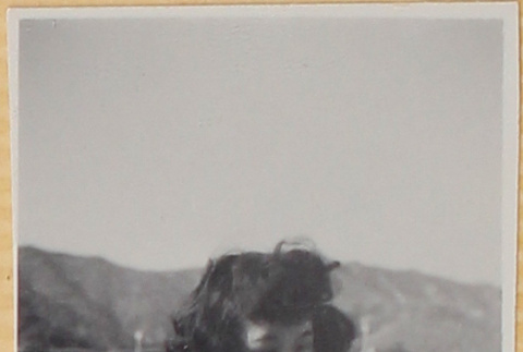 Woman on windy bridge (ddr-densho-522-15)