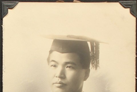 Portrait of a Nikkei man wearing a cap and gown (ddr-densho-259-440)