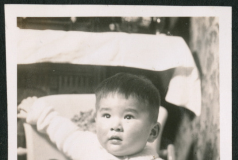 Photo of a child in a high chair (ddr-densho-483-749)