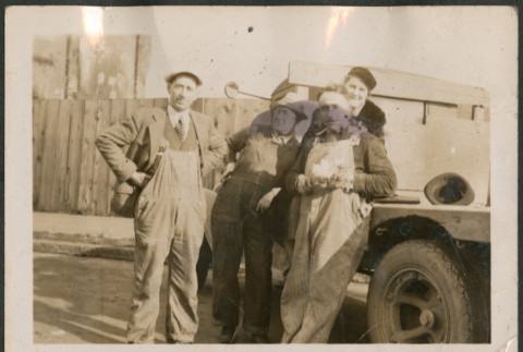 Four men leaning on truck (ddr-densho-316-312)