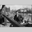 Man sitting by harbor with small boats (ddr-densho-426-2181)