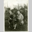 Nisei children in backyard reading a book (ddr-densho-182-74)
