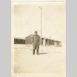 Man in front of camp barracks (ddr-csujad-37-9)