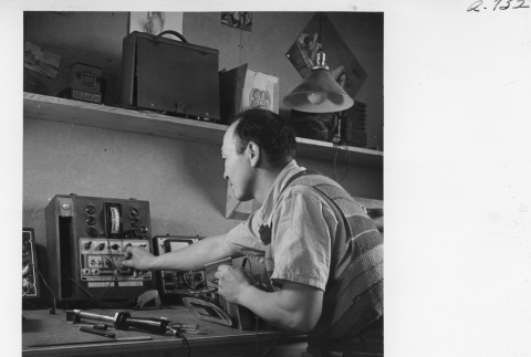 Chester Sakura working in the radio repair shop (ddr-fom-1-843)