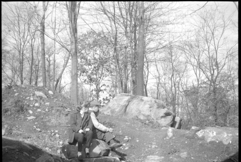 Man and woman sitting on boulder (ddr-densho-377-1402)