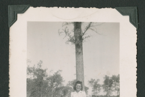 Woman poses in front of a tree (ddr-densho-471-95)