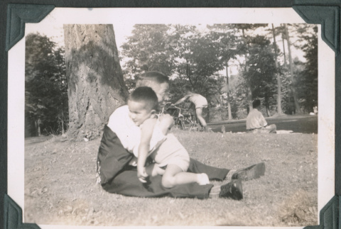 Photo of a man hugging a child (ddr-densho-483-920)