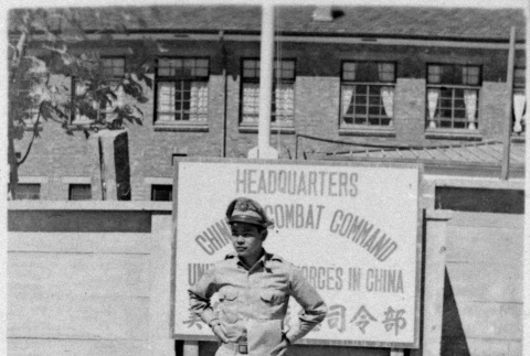 Serviceperson in front of sign (ddr-densho-1007-59)