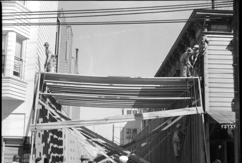 Men framing addition to building (ddr-densho-426-2160)