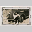Girl holding doll standing in front of car (ddr-densho-426-1927)