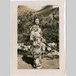 Woman in kimono standing in garden (ddr-densho-426-1866)