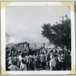 A crowd gathered near a burning barracks (ddr-manz-4-139)
