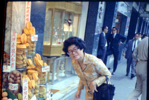 Martha (Nozawa) Tsuchida standing by fruit stand (ddr-densho-426-744)