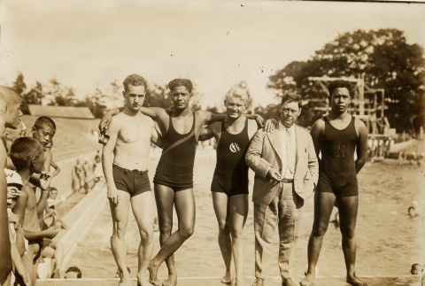 Four swimmers posing with their coach at a pool (ddr-njpa-2-506)