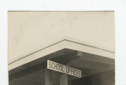 Nisei men and women standing outside the school offices building (ddr-csujad-44-52)