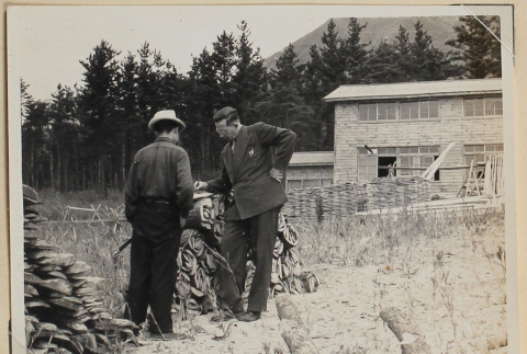 Two men outside a building under construction (ddr-densho-433-739)