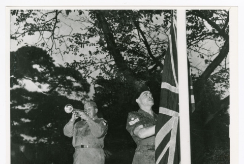 Staff Sergeant Charles F. Lewis lowers flag of the United Kingdom at the closing of Camp Ebisu (ddr-densho-1007-124)