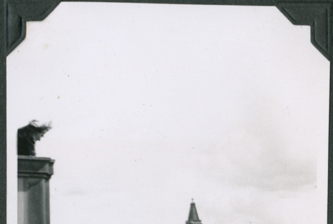 Man looking out over city, with clock tower in background (ddr-ajah-2-599)