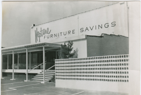 Entrance and parking lot of the Neptune Furniture Savings Supermart (ddr-densho-377-118)