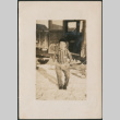 Boy in striped shirt standing by car (ddr-densho-316-239)
