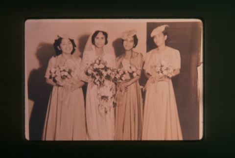 (Slide) - Image of four women in dresses holding flowers (ddr-densho-330-144-master-e4bd0fee0b)