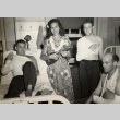 Miss Hawaii playing a ukelele for three wounded soldiers (ddr-njpa-2-851)