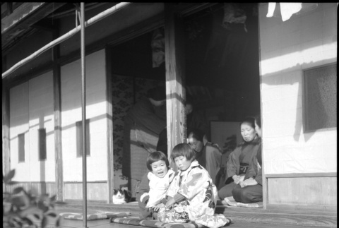 Two children seated outside house (ddr-densho-426-308)