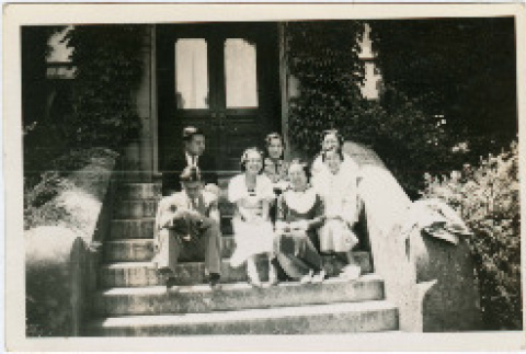 Photo of group sitting on stairs (inside program) (ddr-densho-341-90)
