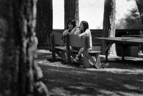 Tom Nakazawa and Carol Sanbongi sitting on a bench (ddr-densho-336-618)