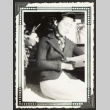 Mit seated and reading a book (ddr-densho-542-374)