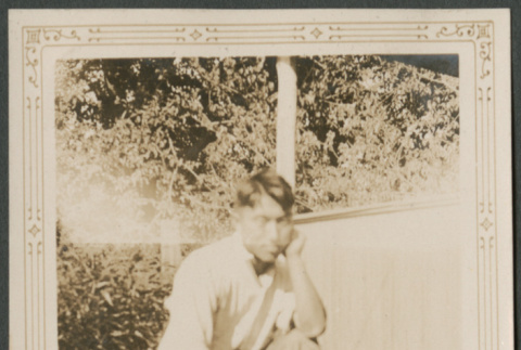Man kneeling in grass (ddr-densho-316-298)