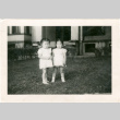 Two young girls standing outside building (ddr-densho-430-183)