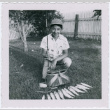 Boy poses with fish catch (ddr-densho-359-1246)