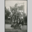 Four people seated under statue (ddr-densho-523-272)
