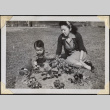 Woman and boy sitting in yard (ddr-densho-466-915)