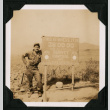 Walter Matsuoka poses by a sign at the 38th parallel north (ddr-densho-390-92)