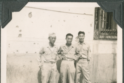 Three men standing by wall. Joe Iwataki on right (ddr-ajah-2-710)