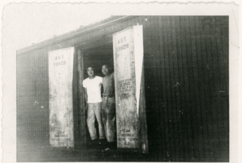 Two men standing in door of boxcar (ddr-densho-122-617)