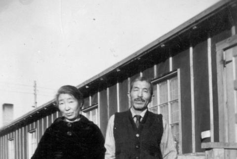 Issei couple standing outside a barrack (ddr-densho-102-20)