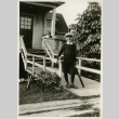 Nisei boy with baseball bat in front of home (ddr-densho-182-78)