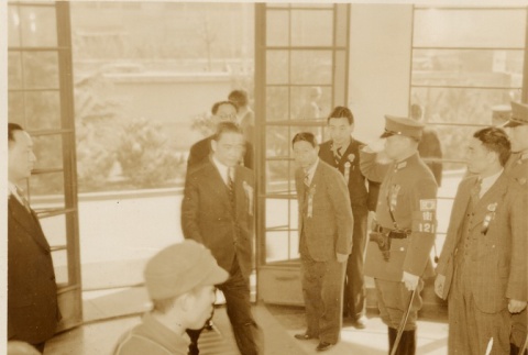 Men and women bowing when entering a building (ddr-njpa-1-1031)