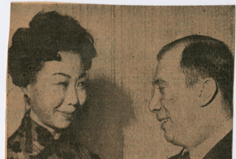 Clipping with photo of Mary Mon Toy presenting ticket to The World of Suzie Wong to Oppenehim Collins executive (ddr-densho-367-226)