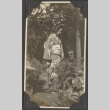 Nobuko Haguri standing in a garden (ddr-densho-432-41)