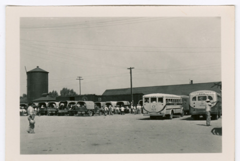 People loading into trucks and buses (ddr-densho-475-390)