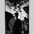 Man standing by car (ddr-densho-426-1728)