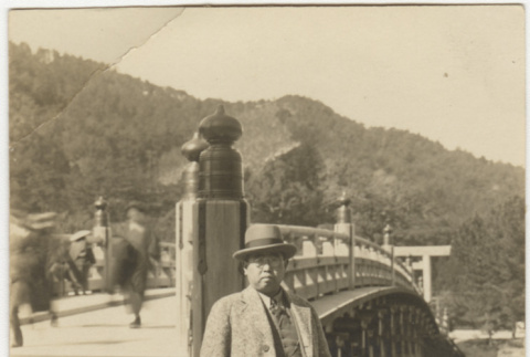 Suejiro Kosai standing next to bridge (ddr-densho-349-38)