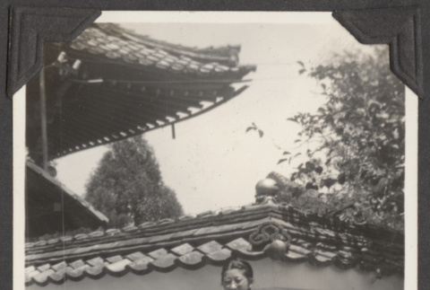 A woman standing in front of a building in Japan (ddr-densho-432-69)