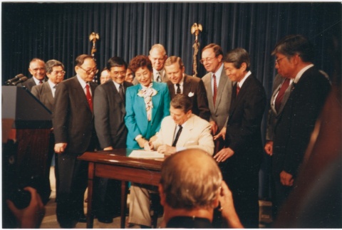 President Ronald Reagan signing the Civil Liberties Act of 1988 (ddr-densho-10-175)